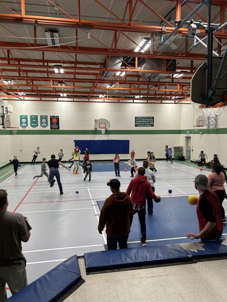 students and parents playing in the gym